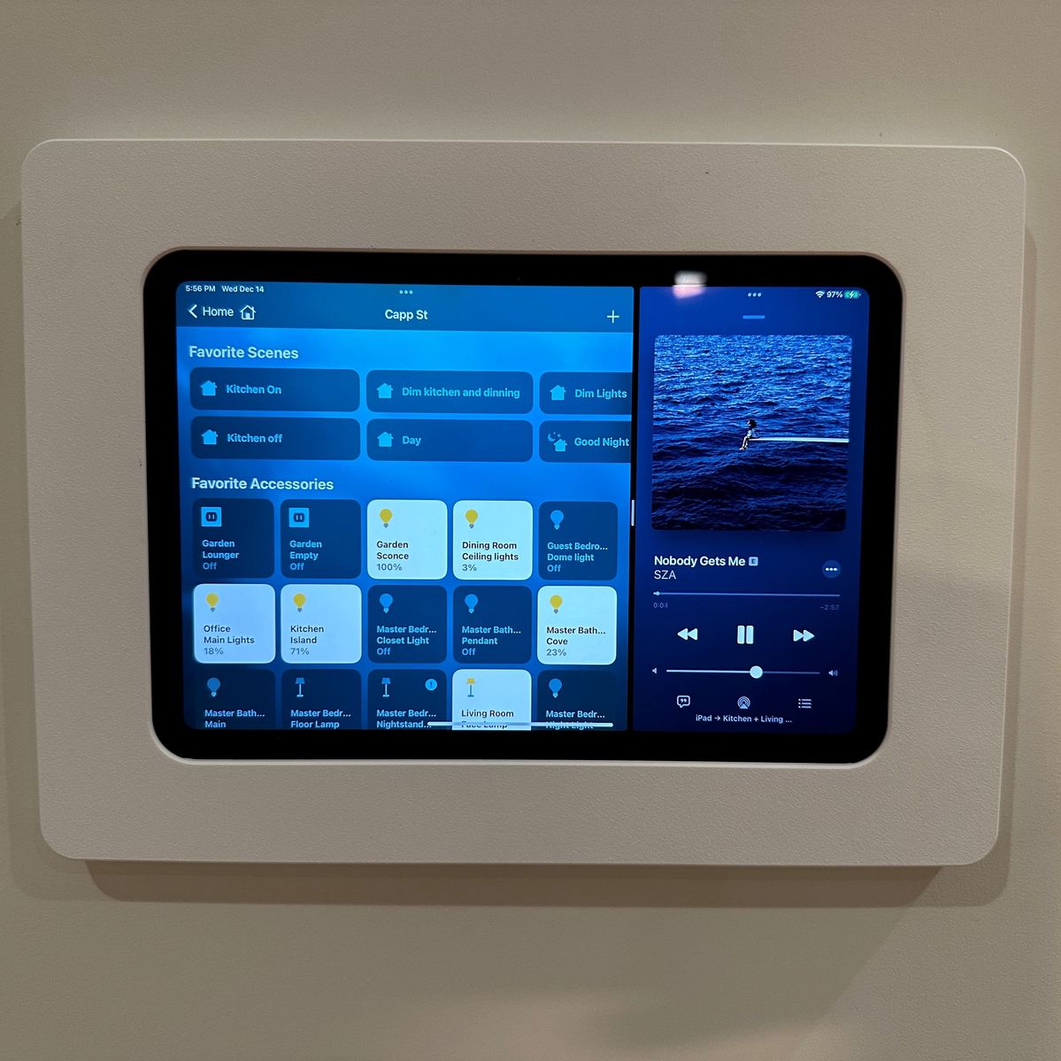 Smart home tablet controlling modern living room lighting