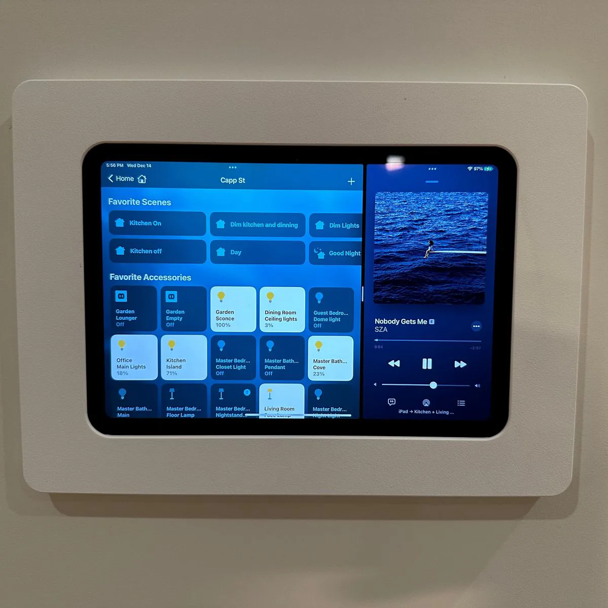 Smart home tablet controlling modern living room lighting